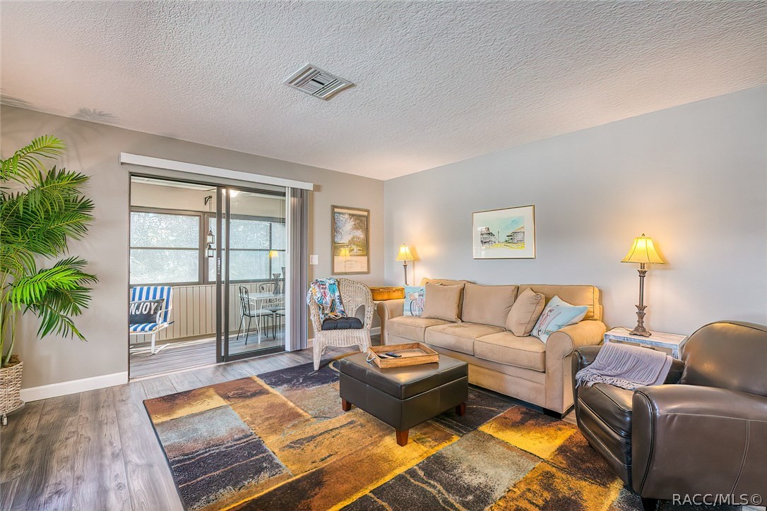 Living Room Opens onto Enclosed Lanai for extra seating or dining. Living Room Opens onto Enclosed Lanai for extra seating or dining.