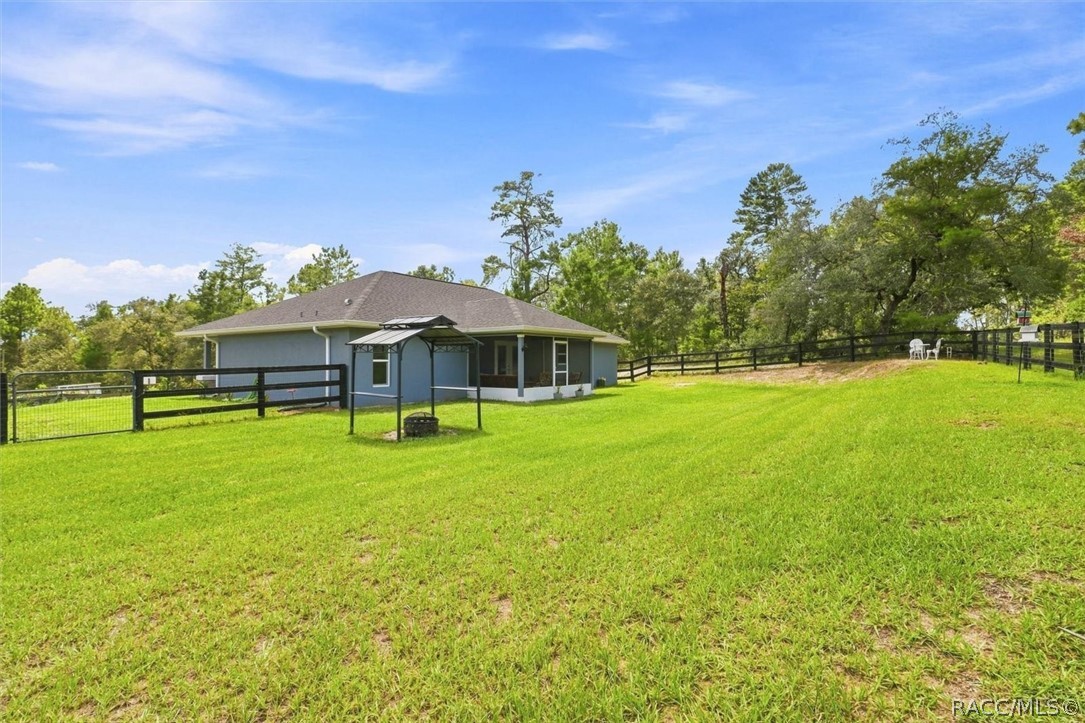 Wire and board fencing and two access gates.  Covered grilling station.