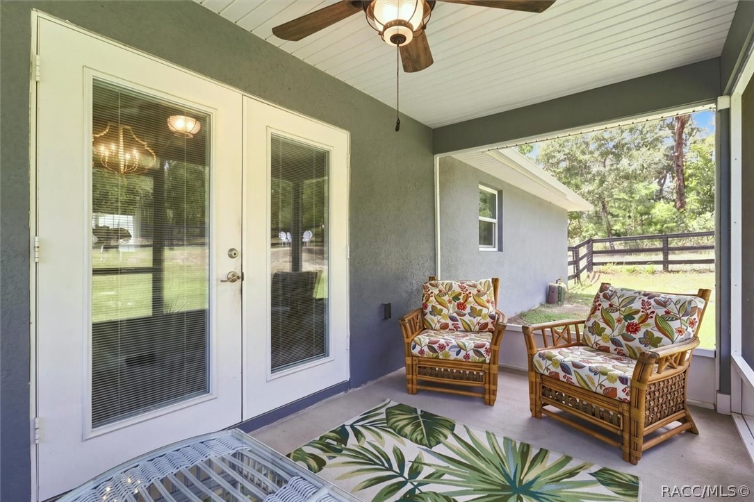 French doors with internal mini blinds lead out to screened lanai