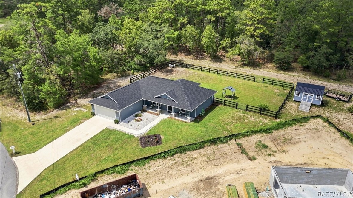 Aerial view of home, fenced backyard and shed