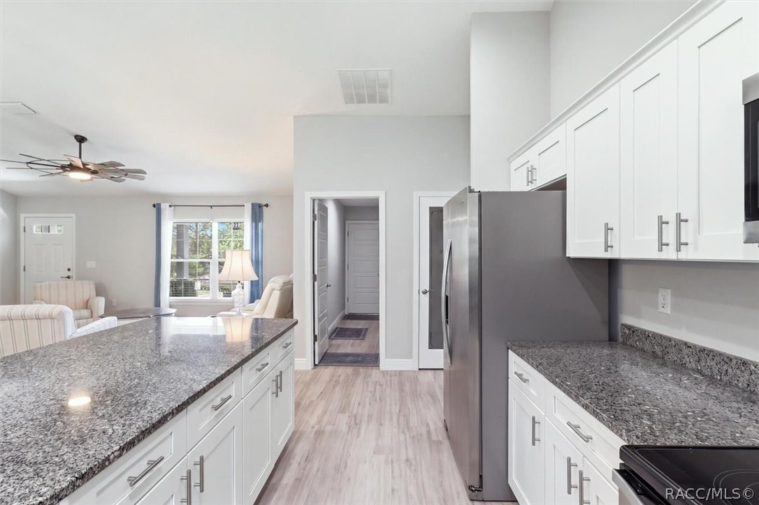 Frosted glass door to pantry is in hallway.  Hallway door leads into laundry room and then to the garage