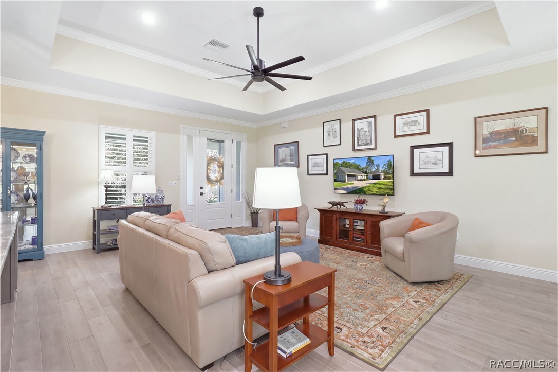 OPEN GREAT ROOM  Spacious living area highlighted by a tray ceiling, oversized modern ceiling fan, crown molding, recessed lighting & an easy open flow into the kitchen and dining spaces.