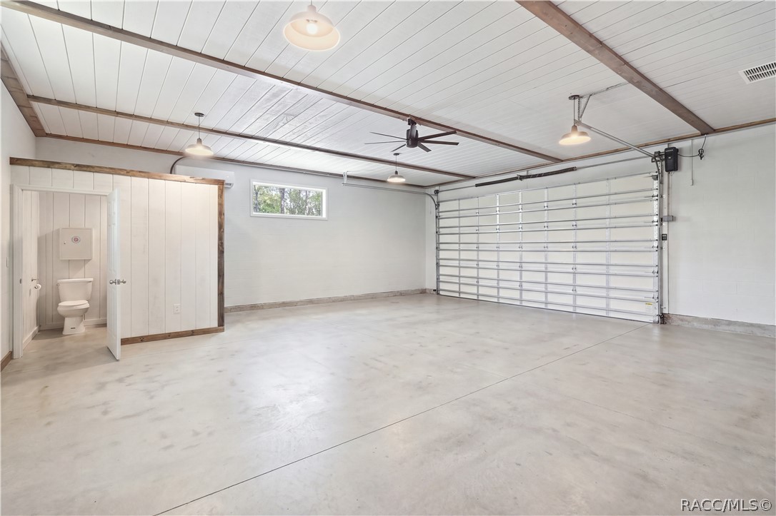 OVERSIZED DETACHED 30x30 GARAGE  THIS IS THE BONUS!
The detached garage delivers serious versatility w/ an expansive open interior, high plank-style ceiling, exposed wood beam accents, multiple pendant lights & a large modern ceiling fan. A full-size garage door provides easy vehicle access, while a separate enclosed area adds even more functionality w/ its own private bathroom.