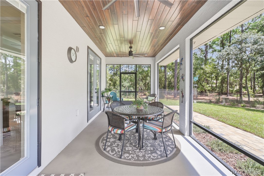 SCREENED LANAI  This is where morning coffee belongs! Generously sized screened lanai features a beautiful wood-plank ceiling, recessed lighting, ceiling fan & plenty of room for outdoor dining and conversation areas while enjoying the private backyard.