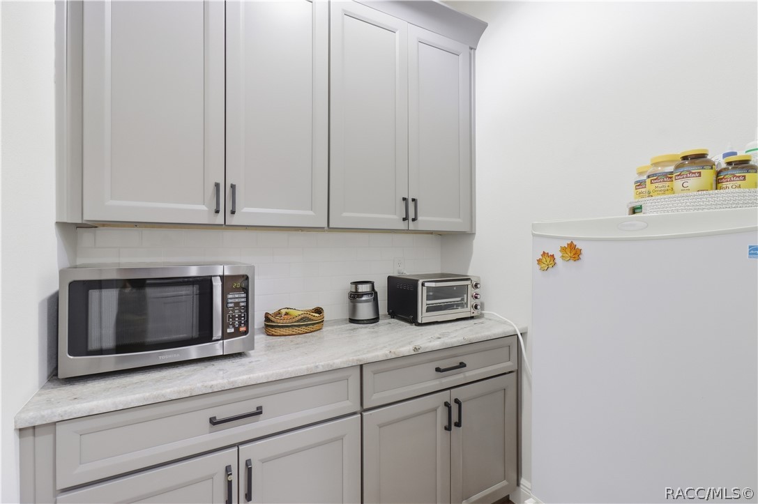 BONUS STORAGE / UTILITY AREA / PANTRY  Additional cabinetry & countertop space provide even more storage for small appliances, household supplies or pantry overflow, plus dedicated space for an additional refrigerator/freezeran incredibly useful extension of the home's storage.
