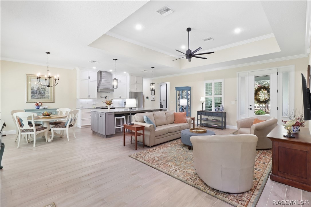 OPEN-CONCEPT LIVING AT ITS BEST!
Bright & spacious open-concept living area seamlessly connects the GREAT ROOM, dining space & kitchen, creating an inviting layout perfect for everyday living & entertaining. Eye-catching details include a tray ceiling w/ crown molding, recessed lighting & modern oversized ceiling fan, luxury-style porcelain tile flooring & abundant natural light. The kitchen anchors the space w/ a contrasting center island, pendant lighting, white cabinetry & UPGRADED stainless appliances.