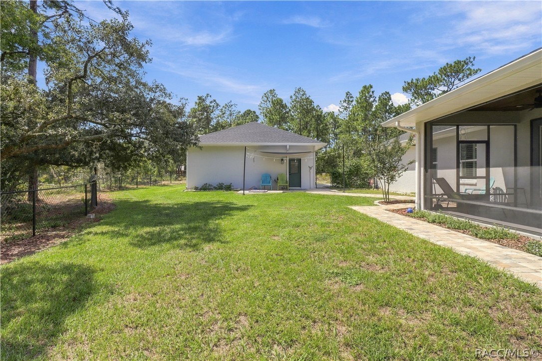 FENCED BACKYARD + DETACHED GARAGE  Spacious backyard provides plenty of room to enjoy the outdoors while the aluminum-style fencing defines the yard without blocking the wooded views. A paver walkway connects the home to the detached garage, creating easy access between both structures.