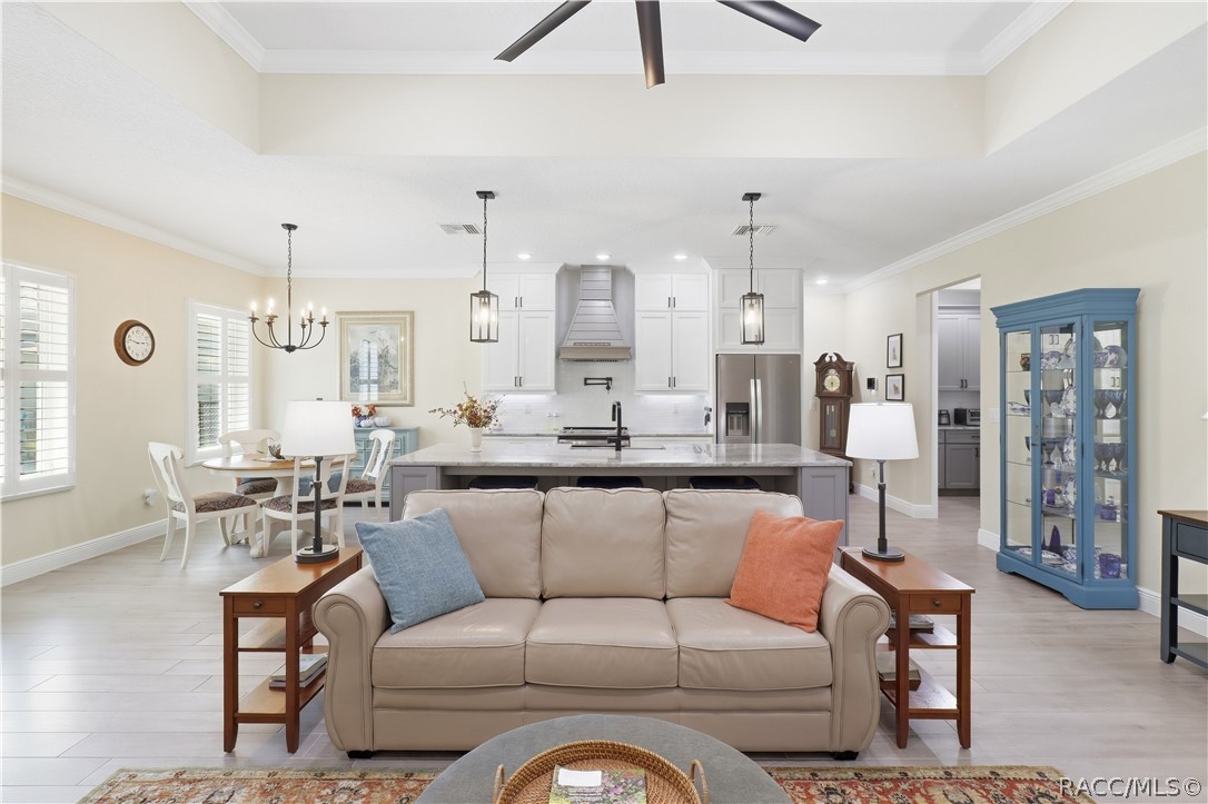 OPEN GREAT ROOM  Spacious living area highlighted by a tray ceiling, oversized modern ceiling fan, crown molding, recessed lighting & an easy open flow into the kitchen and dining spaces.