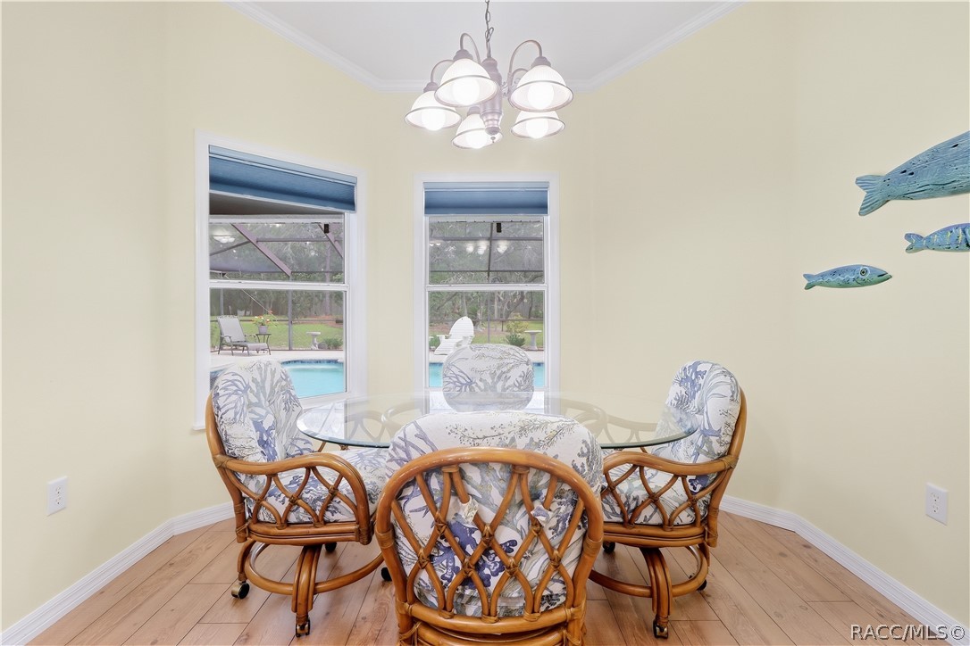 Breakfast Nook  Bright kitchen nook overlooking the screened pool and backyard through multiple windows.