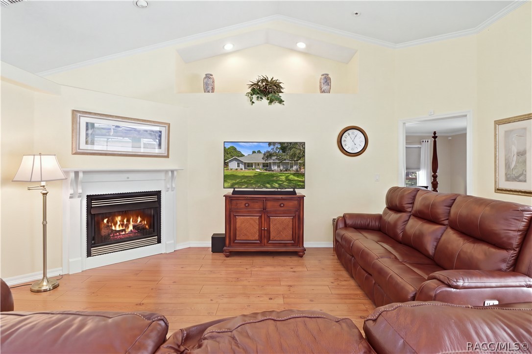 Living Room with GAS Fireplace  Inviting living room featuring a gas fireplace, vaulted ceiling, architectural display ledge, recessed lighting & crown molding. (Gas for the fireplace is not hooked up).