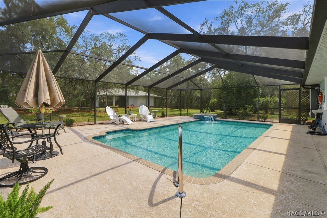 SPACIOUS SCREEN-ENCLOSED POOL  Expansive pool and deck area with plenty of room for swimming, lounging & entertaining.