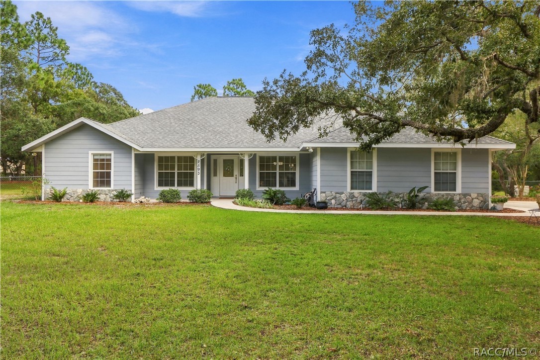 Front Exterior  BRAND NEW ROOF 2026  Full front elevation highlighting the expansive lawn, covered entry porch, mature shade trees. FRESHLY painted exterior trim.