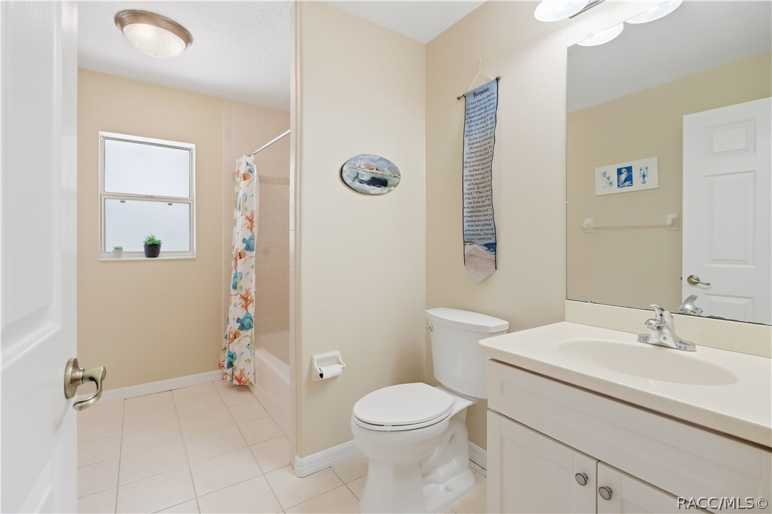 Guest Bathroom  Full guest bath with vanity, tub/shower combination, tile flooring and window for natural light.