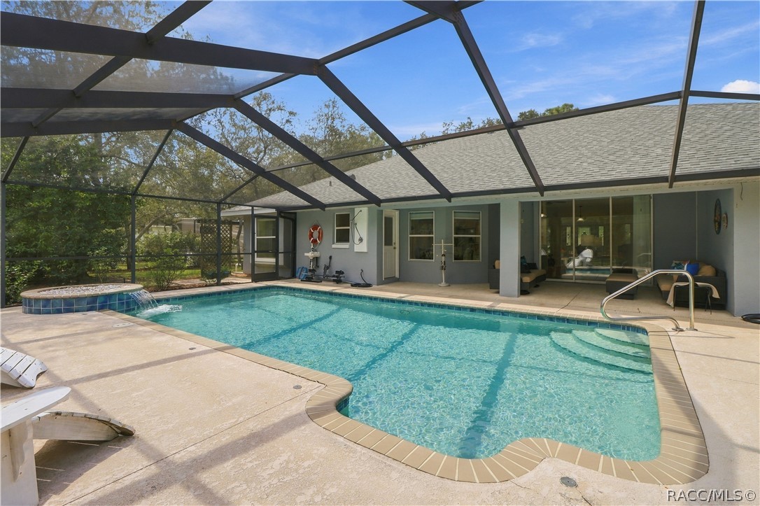 YOUR OWN BACKYARD RETREAT  Large screened pool with generous deck space, covered patio & raised water feature.