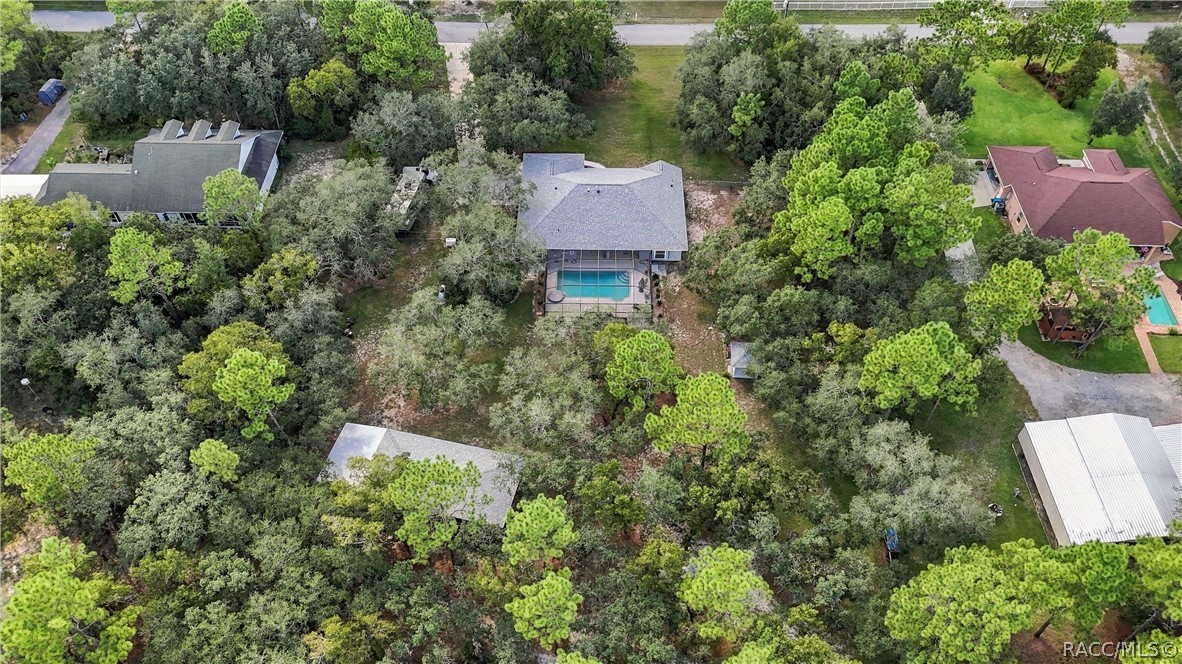 THE BIG PICTURE  Aerial view showcases the home, oversized screened pool, detached garage/outbuilding and expansive property.