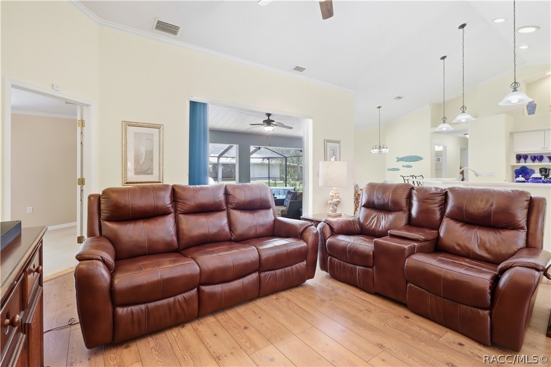 Open Living Area  Spacious living room highlighting the open flow to the kitchen, dining areas & screened pool/lanai.