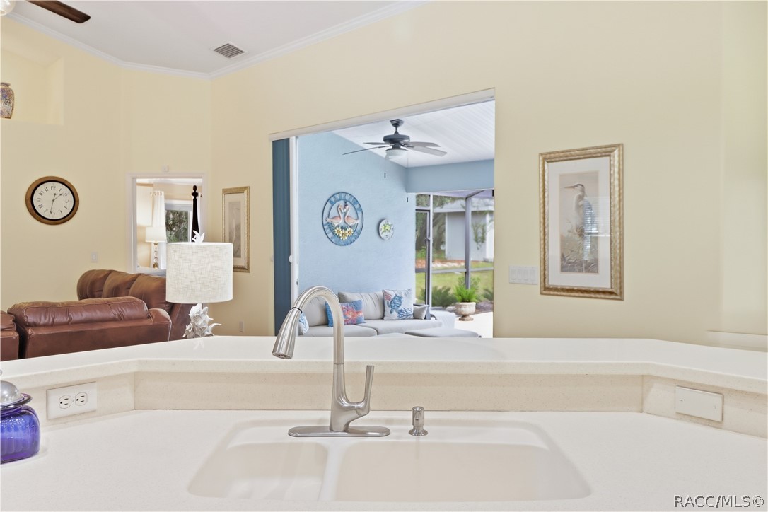 Kitchen Breakfast Bar  Generous counter space with raised breakfast bar, sink & open sightlines into the living room and screened pool lanai.