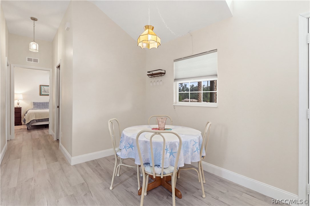 Dining Area & Hallway  An inviting dining space featuring neutral finishes, attractive flooring & an easy flow to the adjoining rooms.