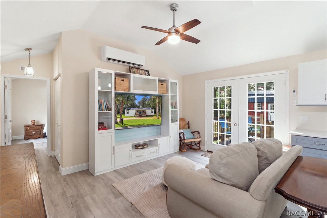 Open Living Area  Another beautiful view of the comfortable living room, showcasing the open layout, attractive furnishings, w/ entertainment center & French doors leading outdoors.