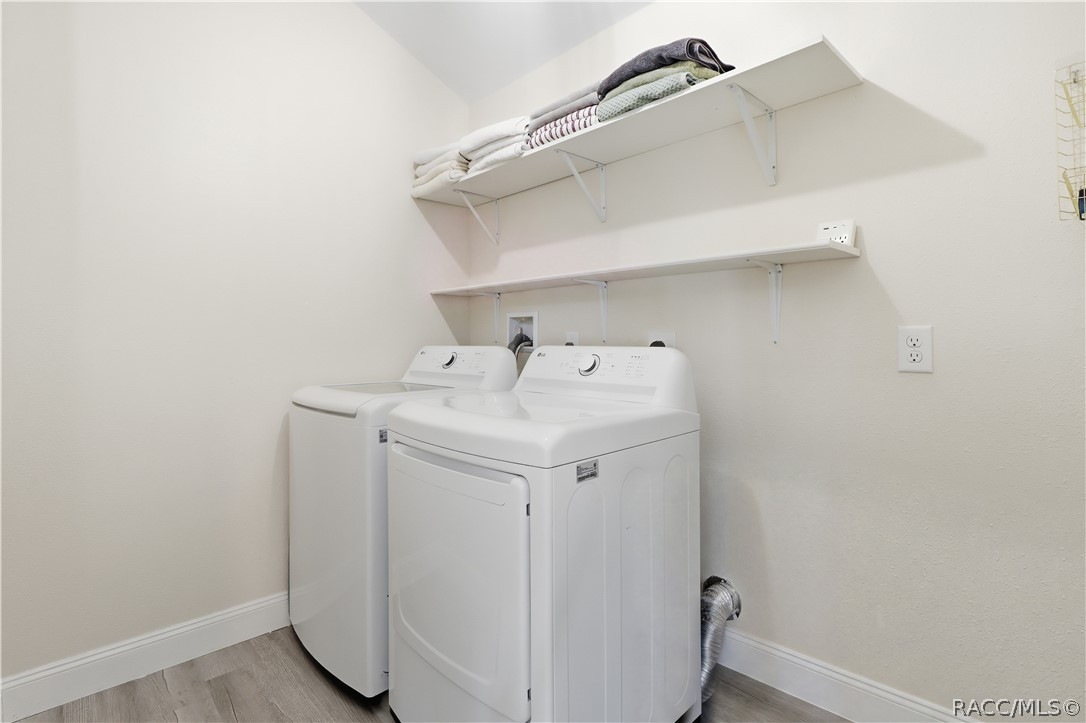 Indoor Laundry Room  Convenient INDOOR LAUNDRY featuring a washer, dryer & overhead shelving for additional storage. Everything has its place!