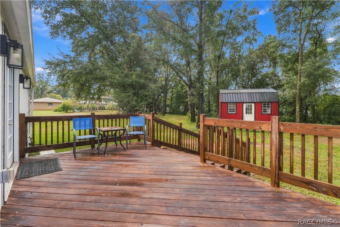 Rear Deck  Step outside & enjoy the spacious WOODEN REAR DECK overlooking the backyard! A wonderful spot for morning coffee, outdoor conversation or relaxing beneath the surrounding trees.