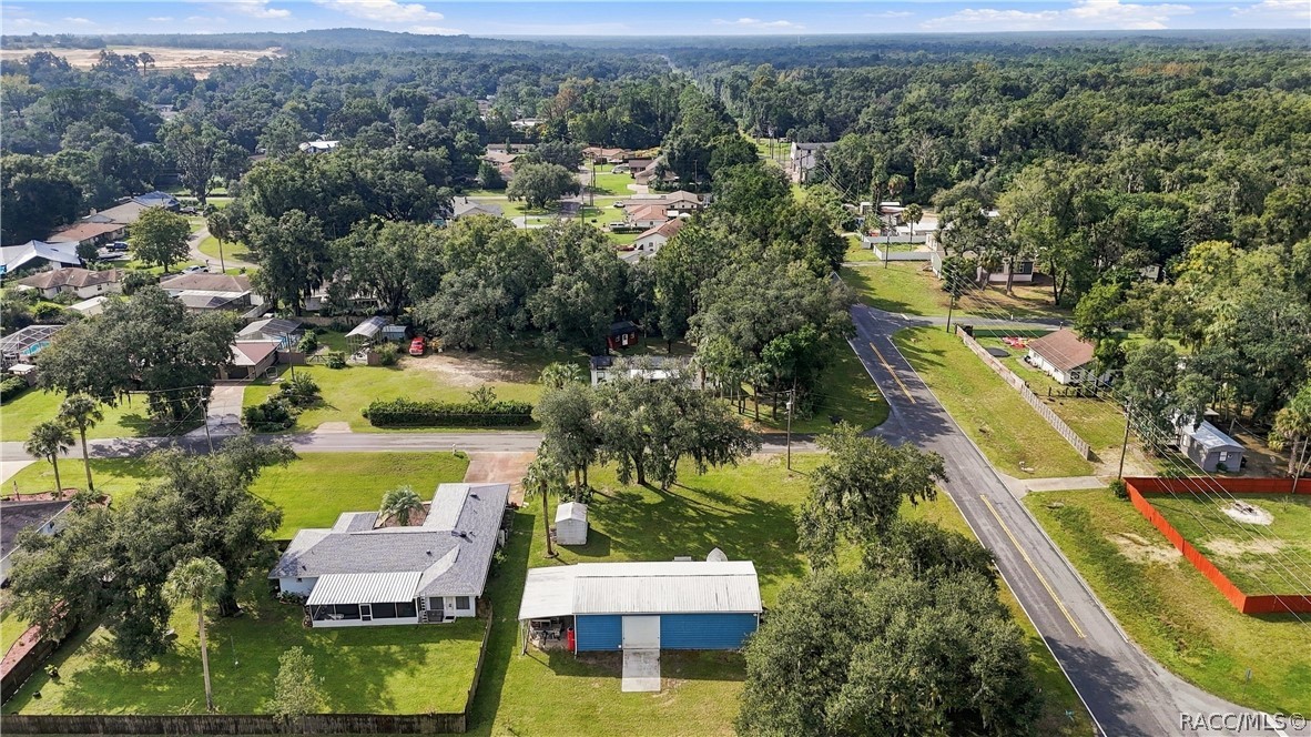 Neighborhood Aerial View  Wide aerial perspective capturing the surrounding neighborhood, tree-lined streets & established residential setting.