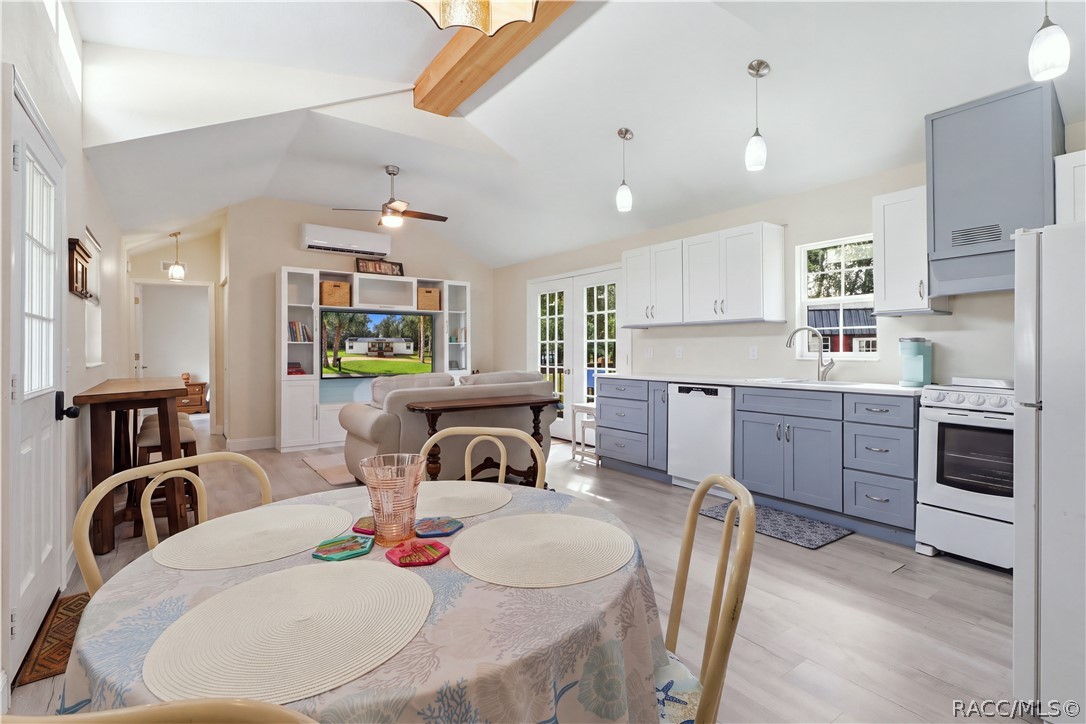 Open Living & Kitchen Area  Light-filled OPEN FLOOR PLAN featuring VAULTED CEILINGS, attractive flooring, pendant lighting & a beautifully coordinated kitchen.