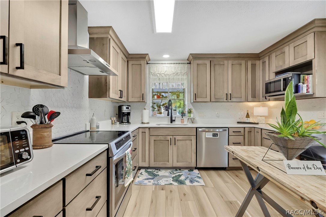 Kitchen with island and sink beneath the window.