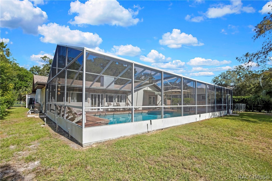 Screen pool enclosure viewed from the backyard.