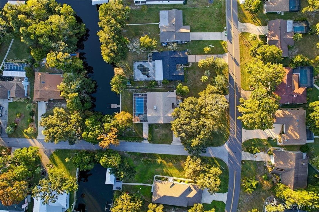 Overhead aerial of the home, pool, and canal.