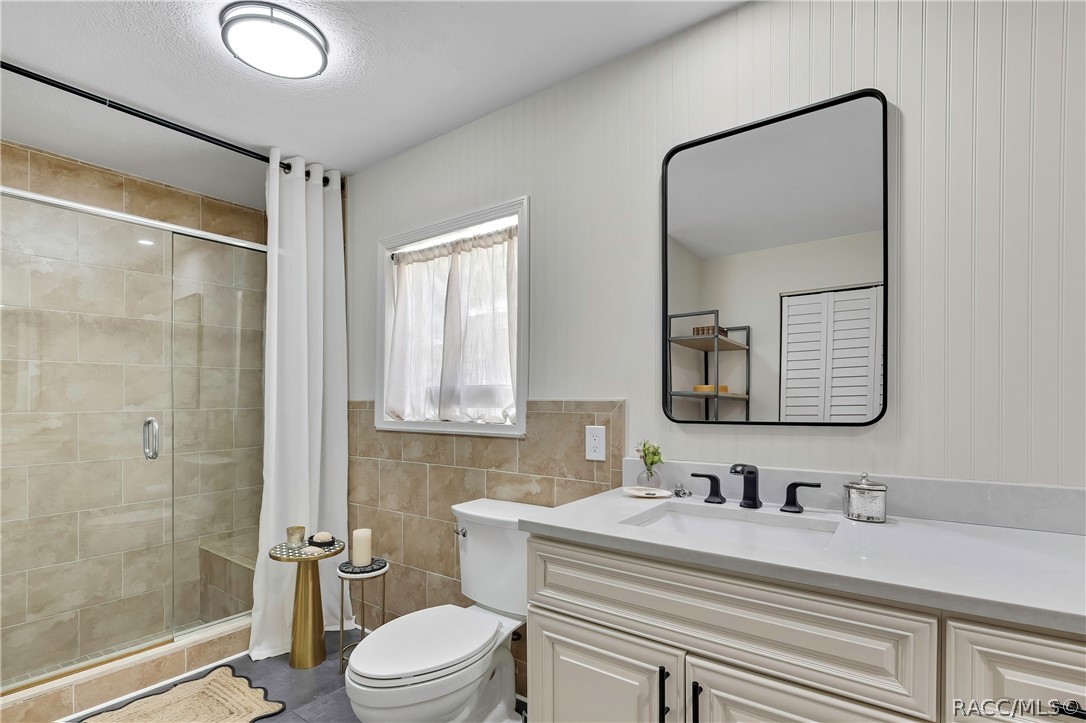 Bathroom with shower, toilet, and vanity.