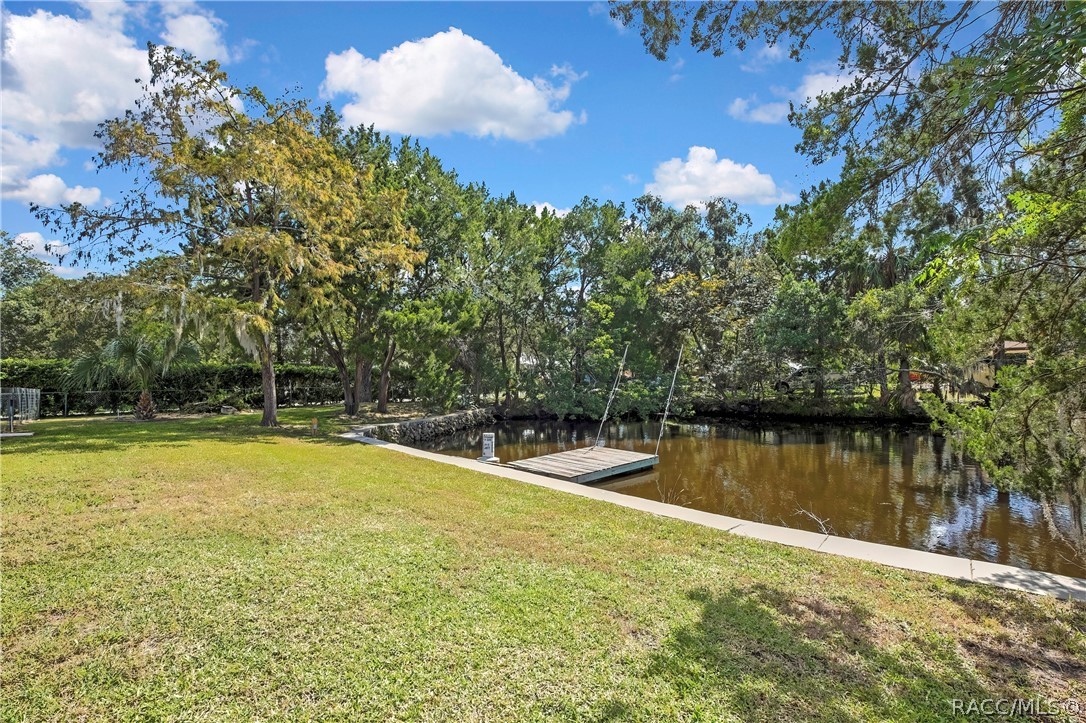Backyard lawn sloping to the canal.
