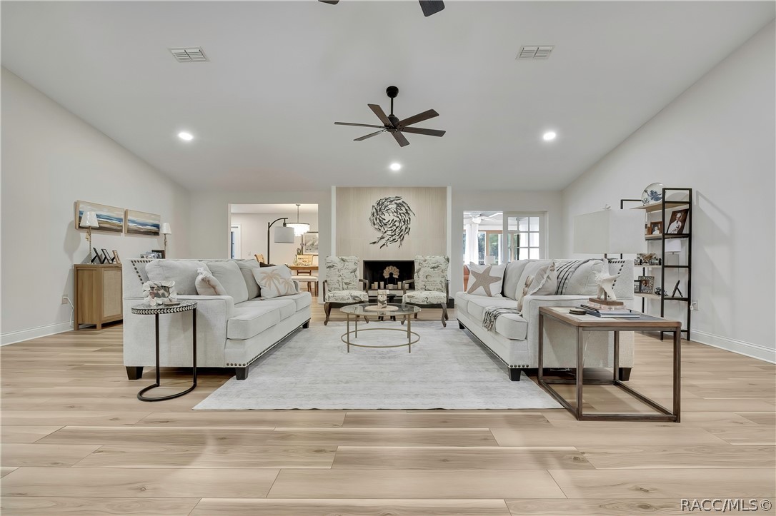 Main living area with vaulted ceiling and wood-look floors. Main living area with vaulted ceiling and wood-look floors.
