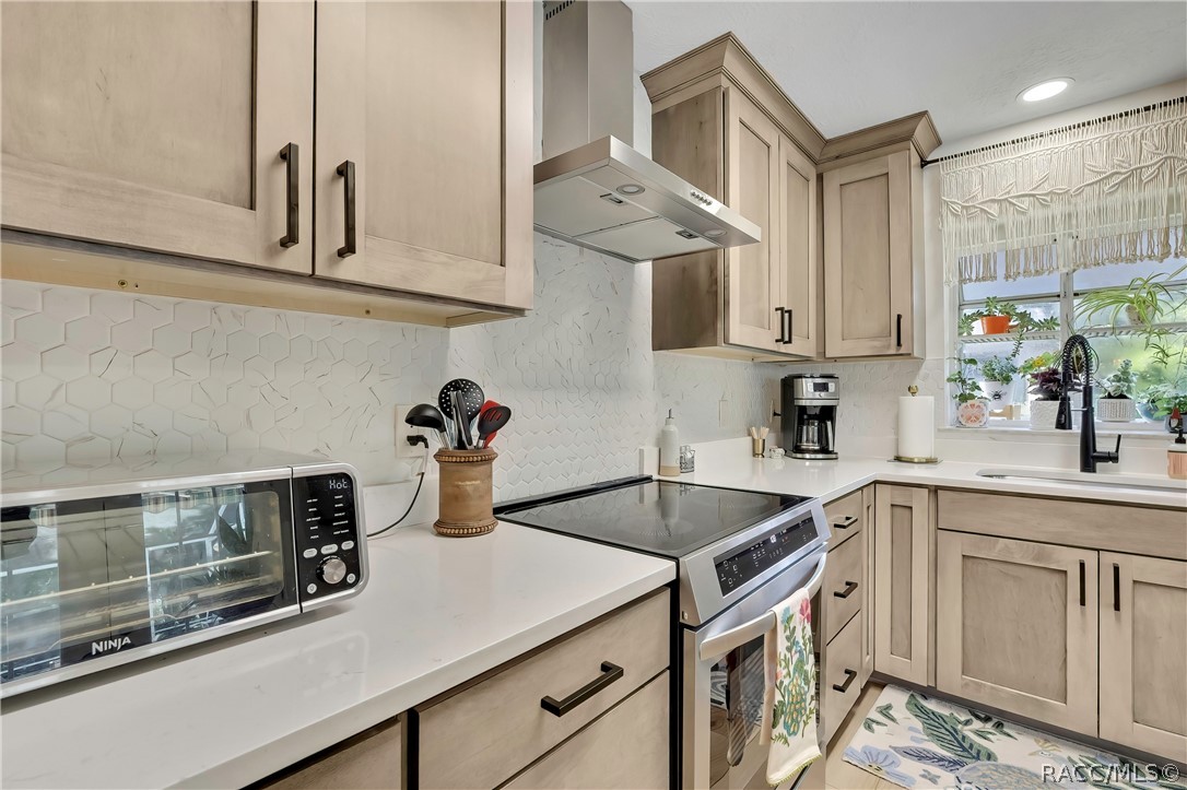 Cooking area with electric range and counter space.