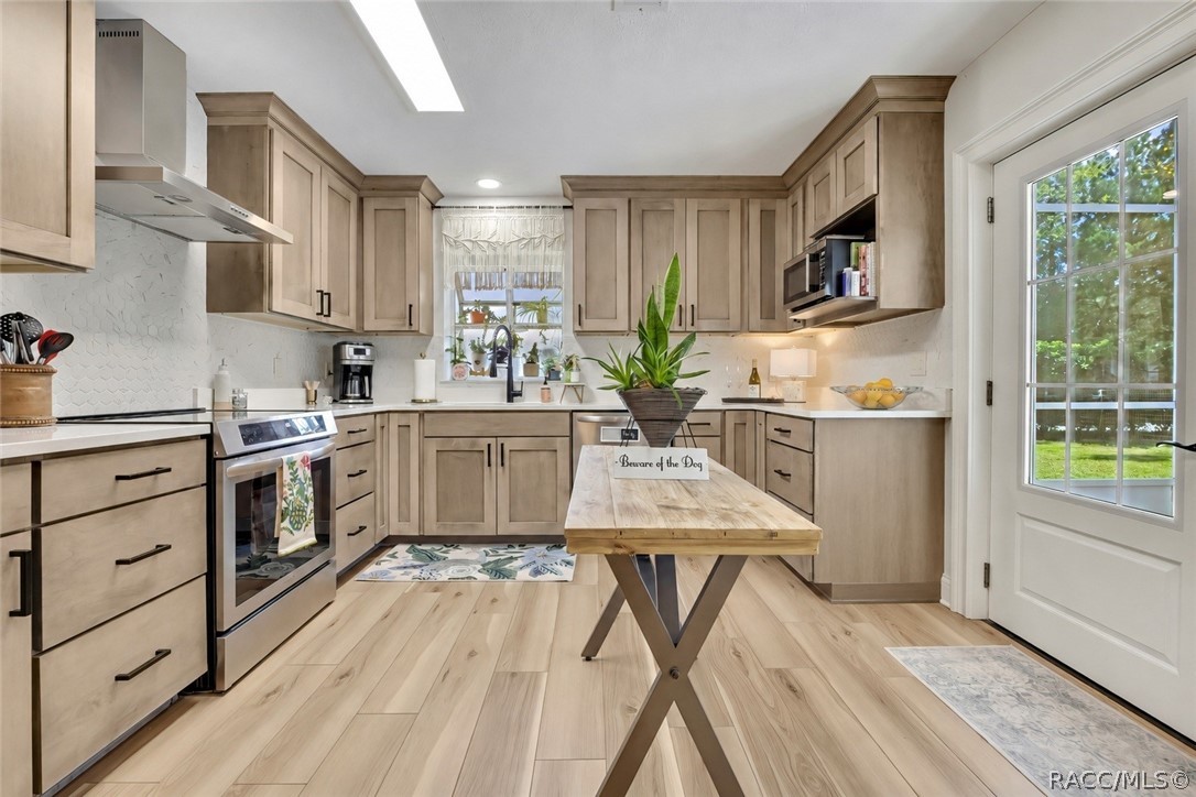Kitchen with center island and wood-look floors.