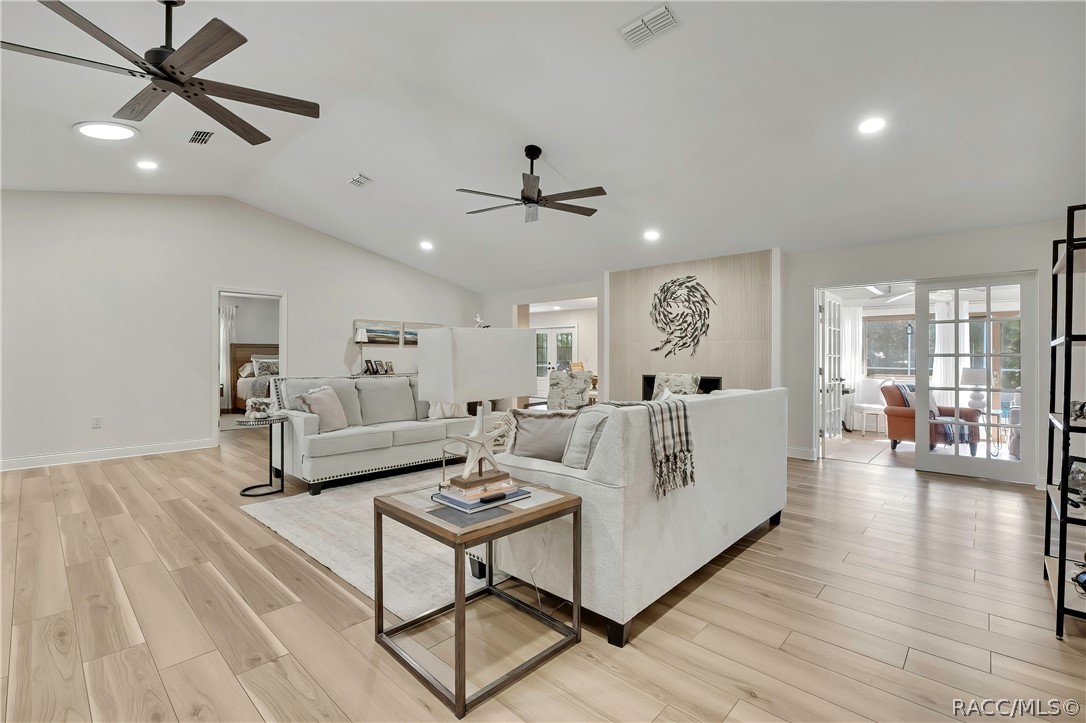 Living area with ceiling fan and sliding doors.