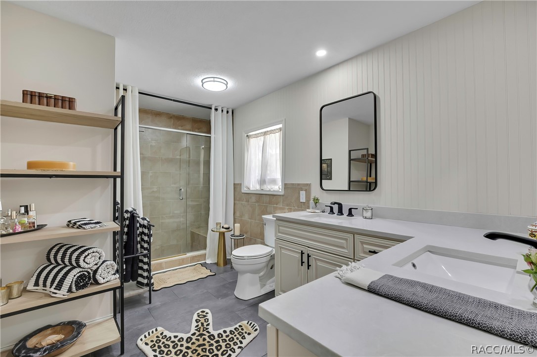 Primary bathroom with vanity and glass shower