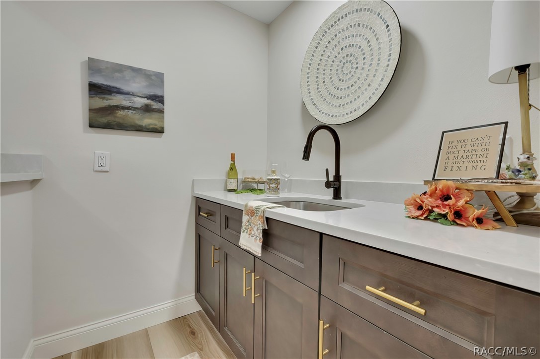 Wet bar with sink and cabinet storage off the living area.