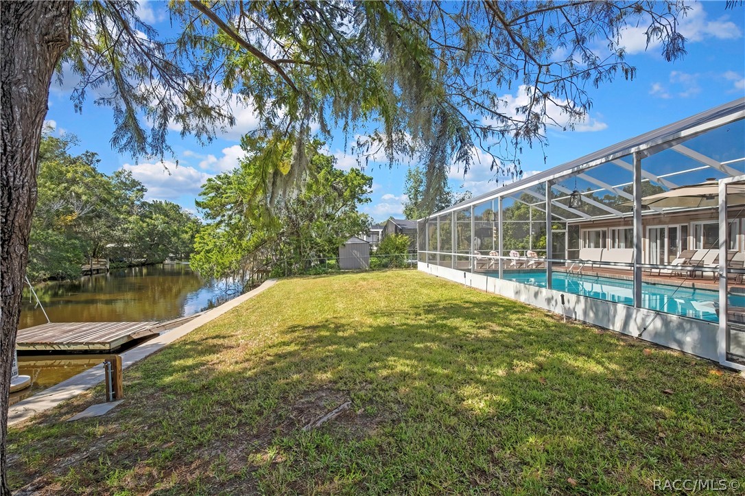 Backyard between the pool enclosure and the canal.