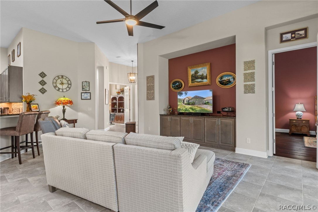 The greatroom features a built-in entertainment center with granite top, provides additional storage and becomes the focal point of the room. The doorway on the right leads into the primary suite.