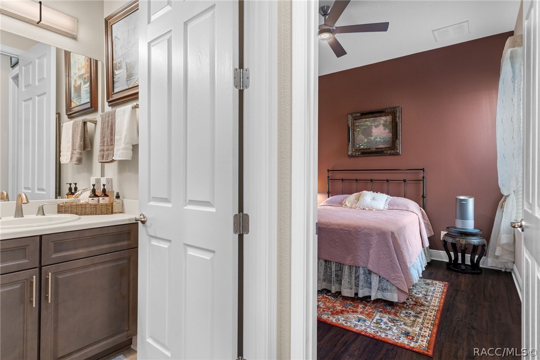 The same color theme is carried through the home in both the bathroom cabinetry, paint colors, and LVP flooring.