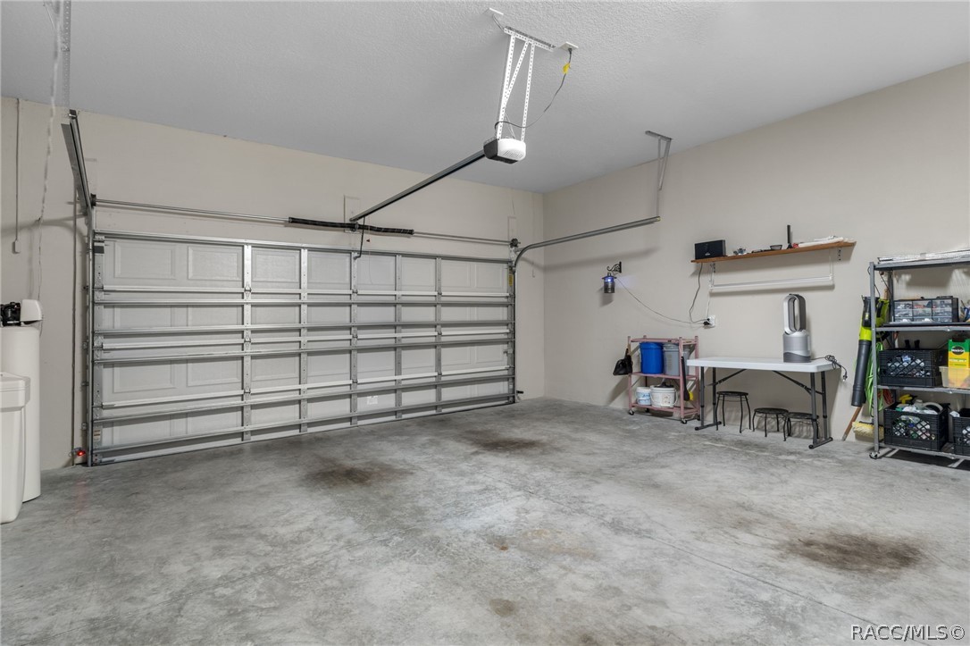 The 22' by 23' two car garage houses a water softener that stays with the house and has room for some storage and two vehicles.