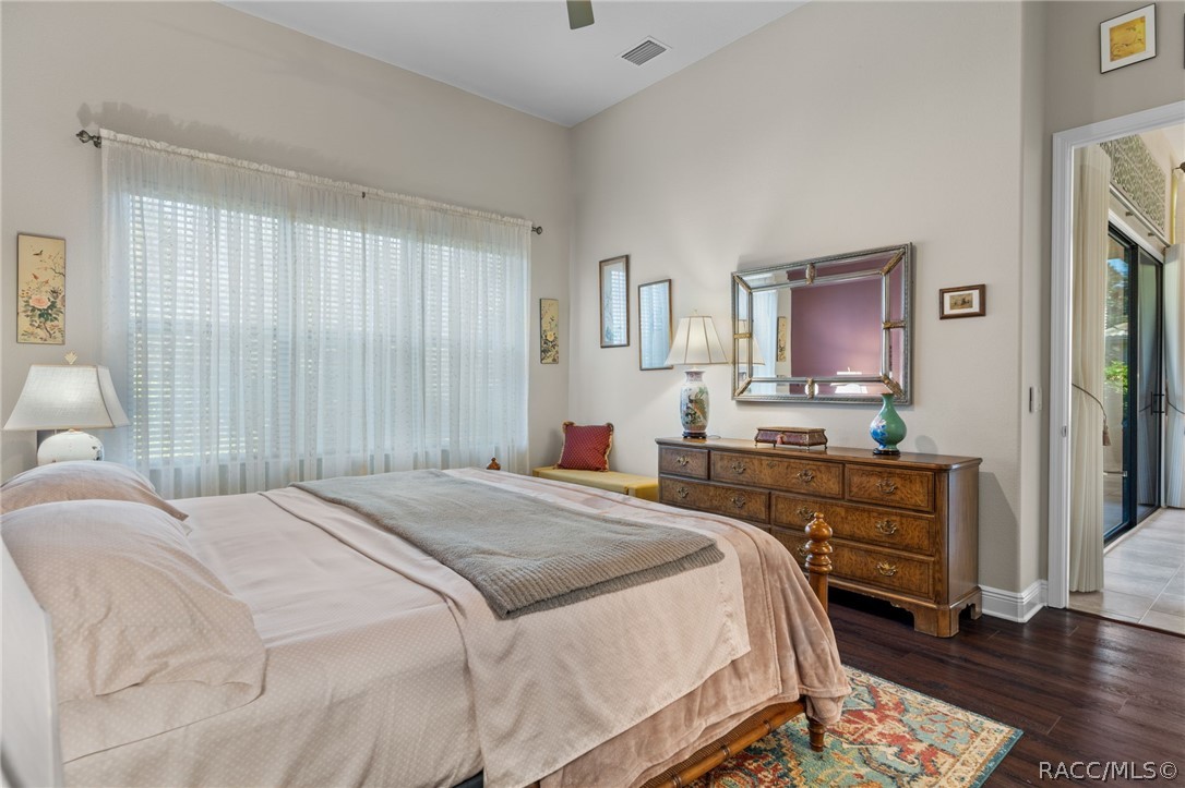 The spacious bedroom offers room for several pieces of furniture and overlooks the backyard.