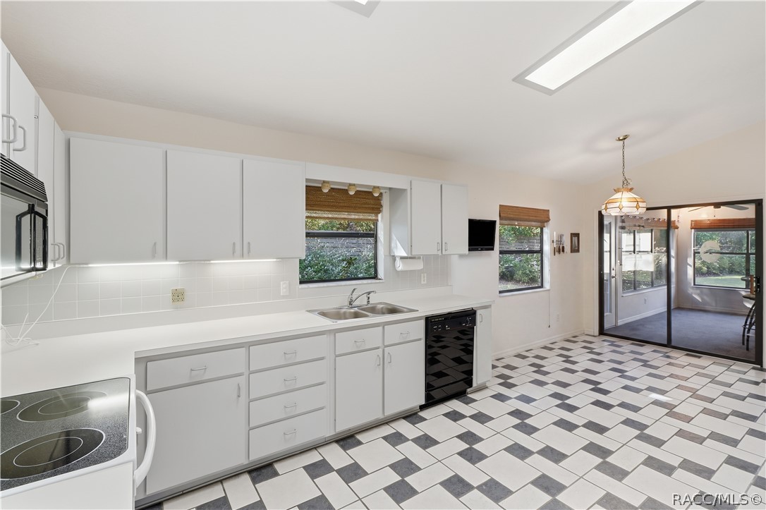 A KITCHEN WITH ROOM TO MOVE! Generous countertop space, abundant cabinetry, DOUBLE-BASIN SINK & convenient access to the ENCLOSED FLORIDA ROOM! A KITCHEN WITH ROOM TO MOVE! Generous countertop space, abundant cabinetry, DOUBLE-BASIN SINK & convenient access to the ENCLOSED FLORIDA ROOM!