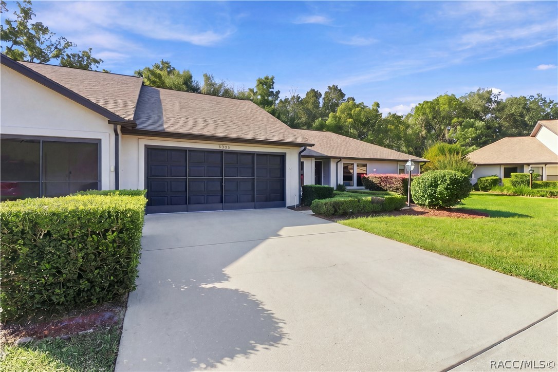 PULL RIGHT IN! Spacious CONCRETE DRIVEWAY leads to the attached 2-CAR GARAGE, surrounded by lush green lawn & attractive landscaping! PULL RIGHT IN! Spacious CONCRETE DRIVEWAY leads to the attached 2-CAR GARAGE, surrounded by lush green lawn & attractive landscaping!