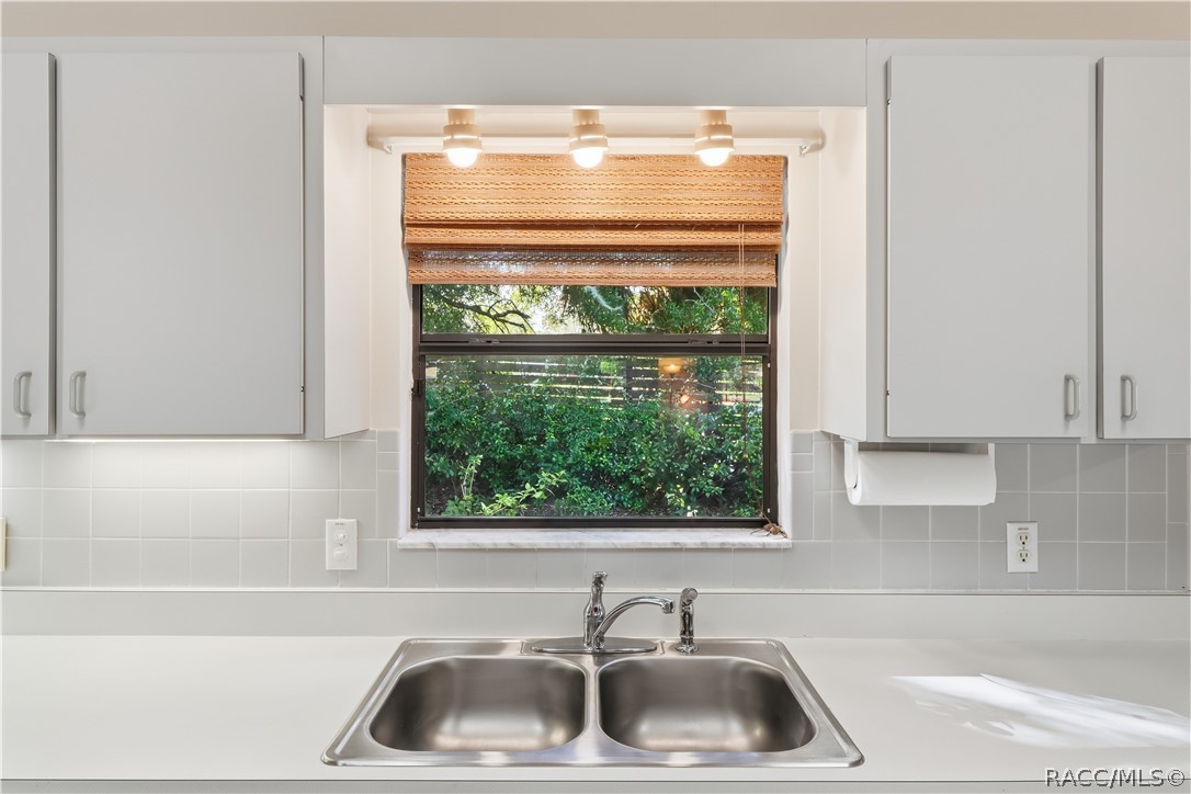 EVERYTHING IN ITS PLACE! Kitchen DOUBLE-BASIN STAINLESS STEEL SINK is perfectly positioned beneath a window overlooking the greenery!
