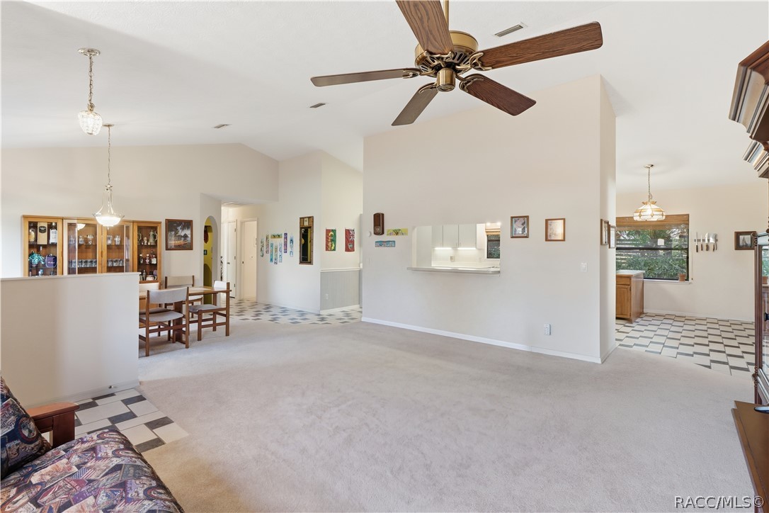 OPEN SPACES, ENDLESS POSSIBILITIES! Spacious LIVING ROOM features soaring VAULTED CEILINGS & an OPEN FLOOR PLAN connecting the dining area & kitchen!