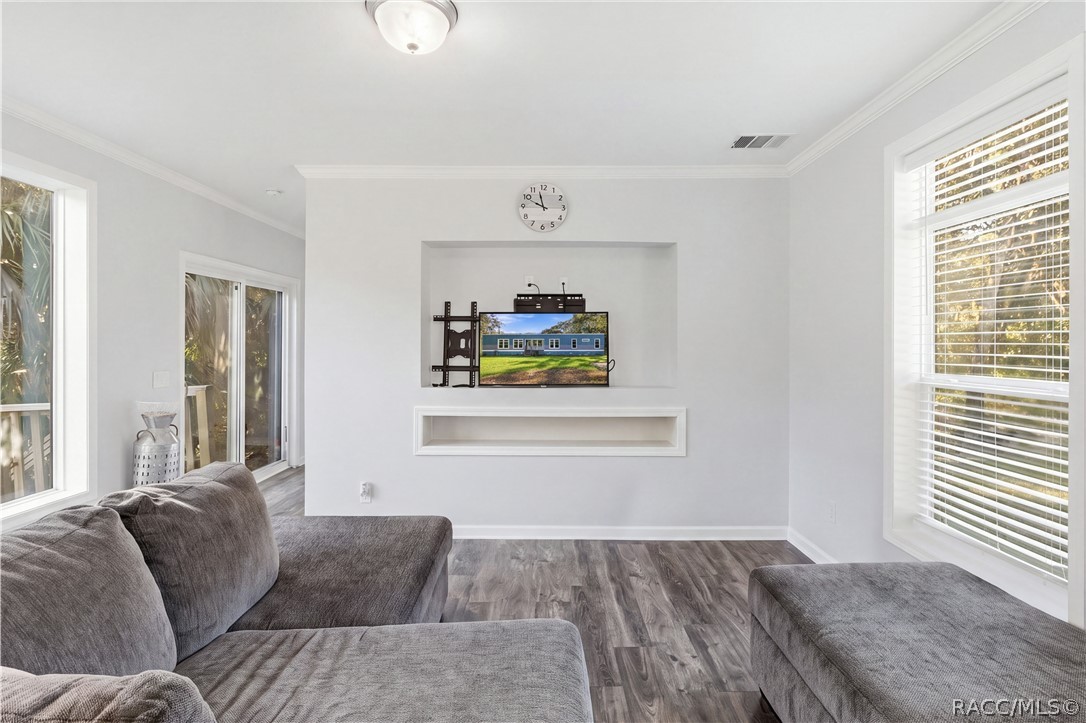 A COZY PLACE TO UNWIND! Enjoy the comfortable living area featuring large windows, neutral finishes & a recessed entertainment space.