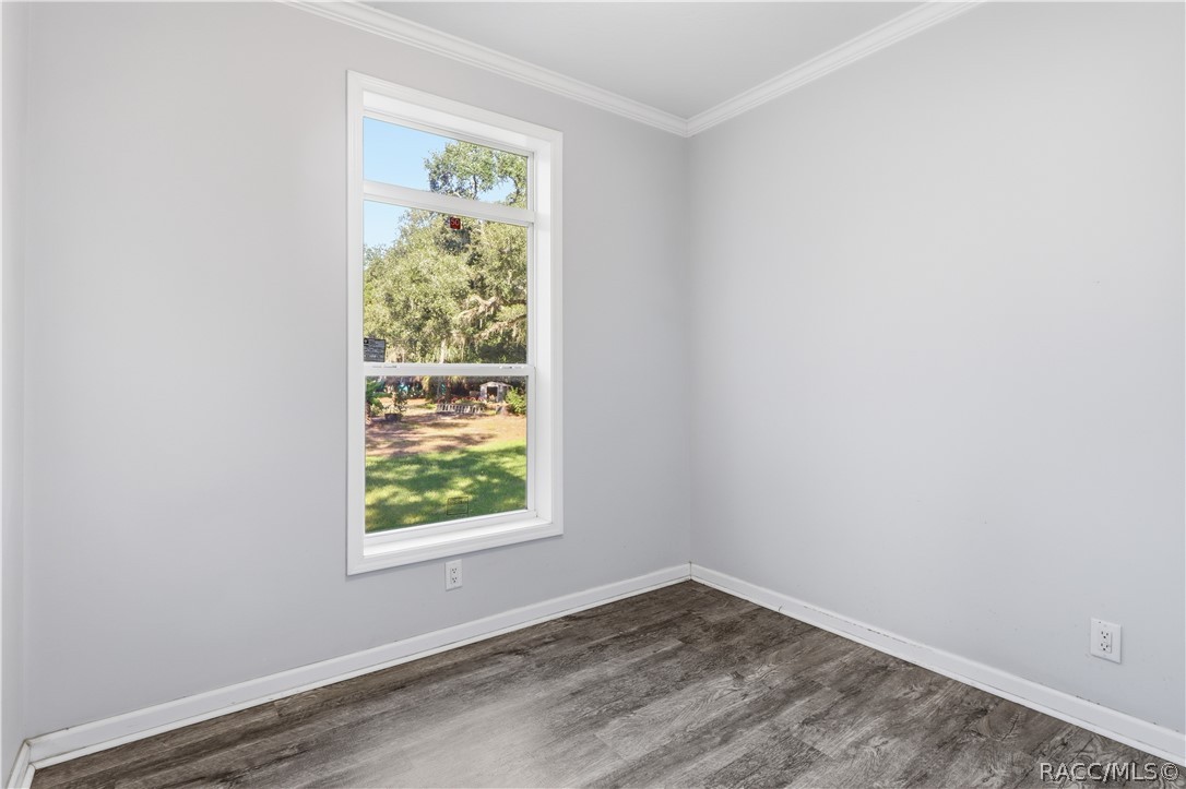 A ROOM TO MAKE YOUR OWN! This additional room features LUXURY VINYL PLANK FLOORING, crown molding, neutral colors & a window overlooking the greenery.