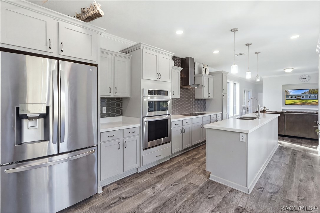 STYLE MEETS FUNCTION! The thoughtfully designed kitchen features GRAY CABINETRY, a DOUBLE-BASIN SINK, sleek spring-style faucet & large windows overlooking the beautiful outdoors.